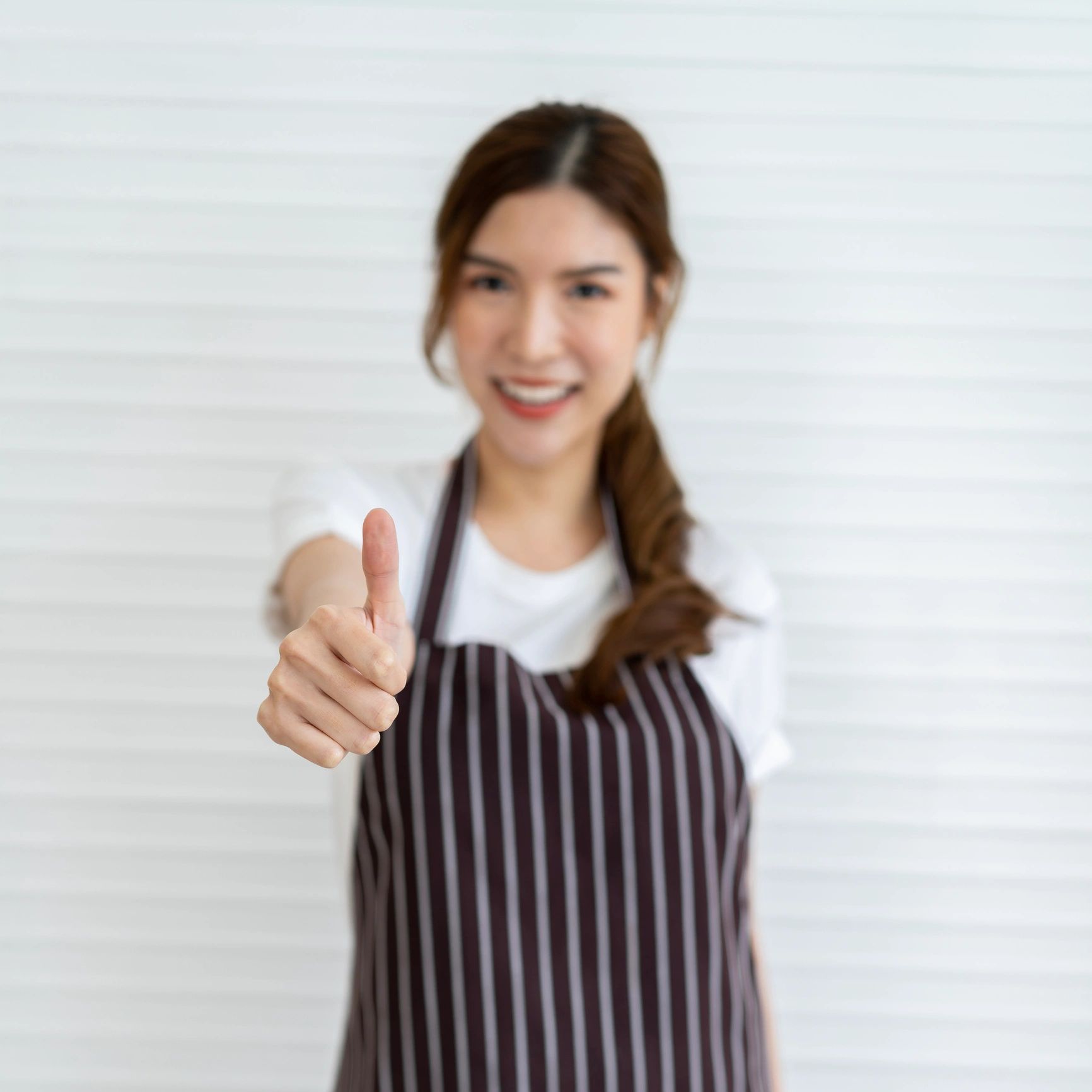 Cafe team member portrait giving a thumbs up