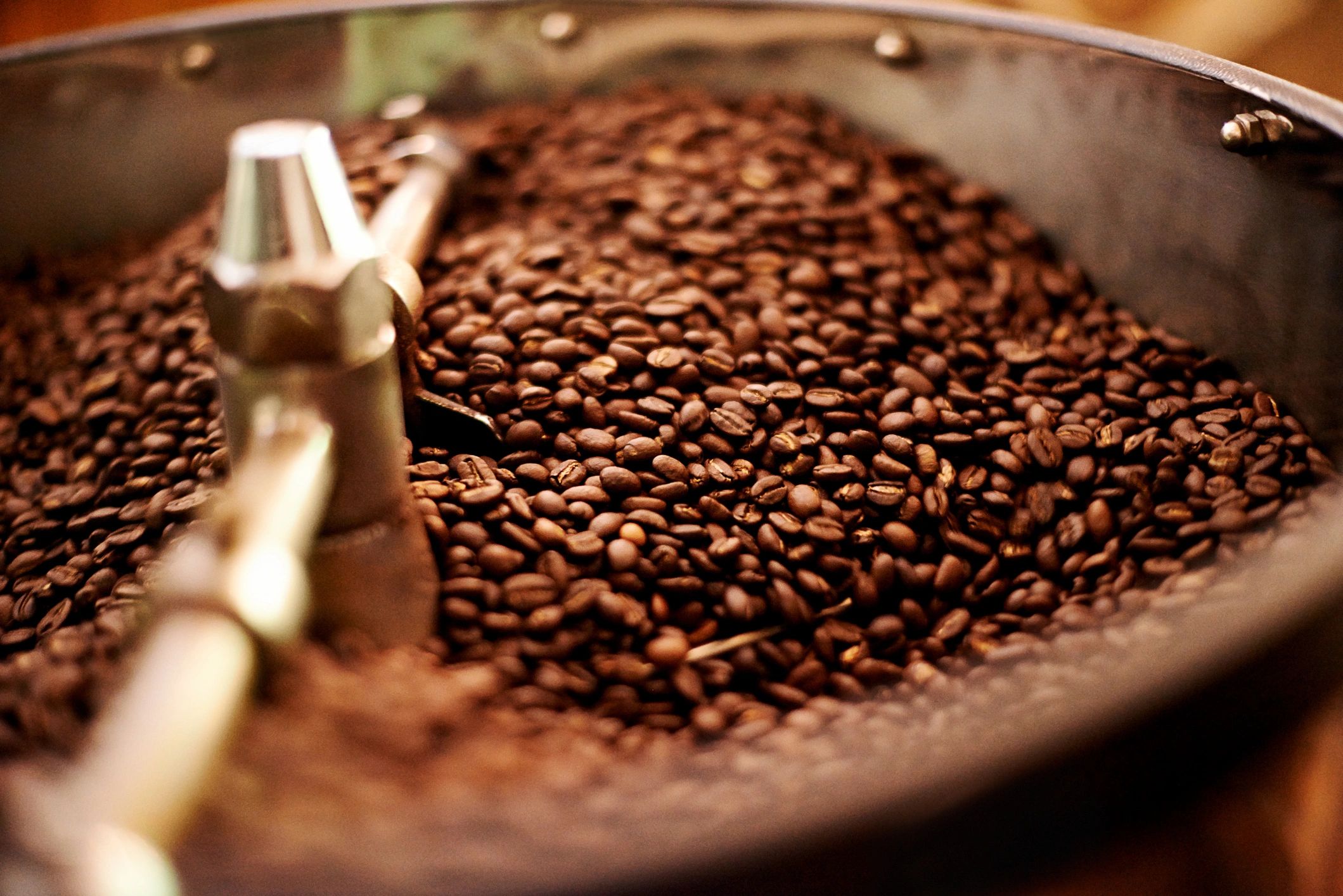 Coffee beans and roasting equipment in a coffee production setting