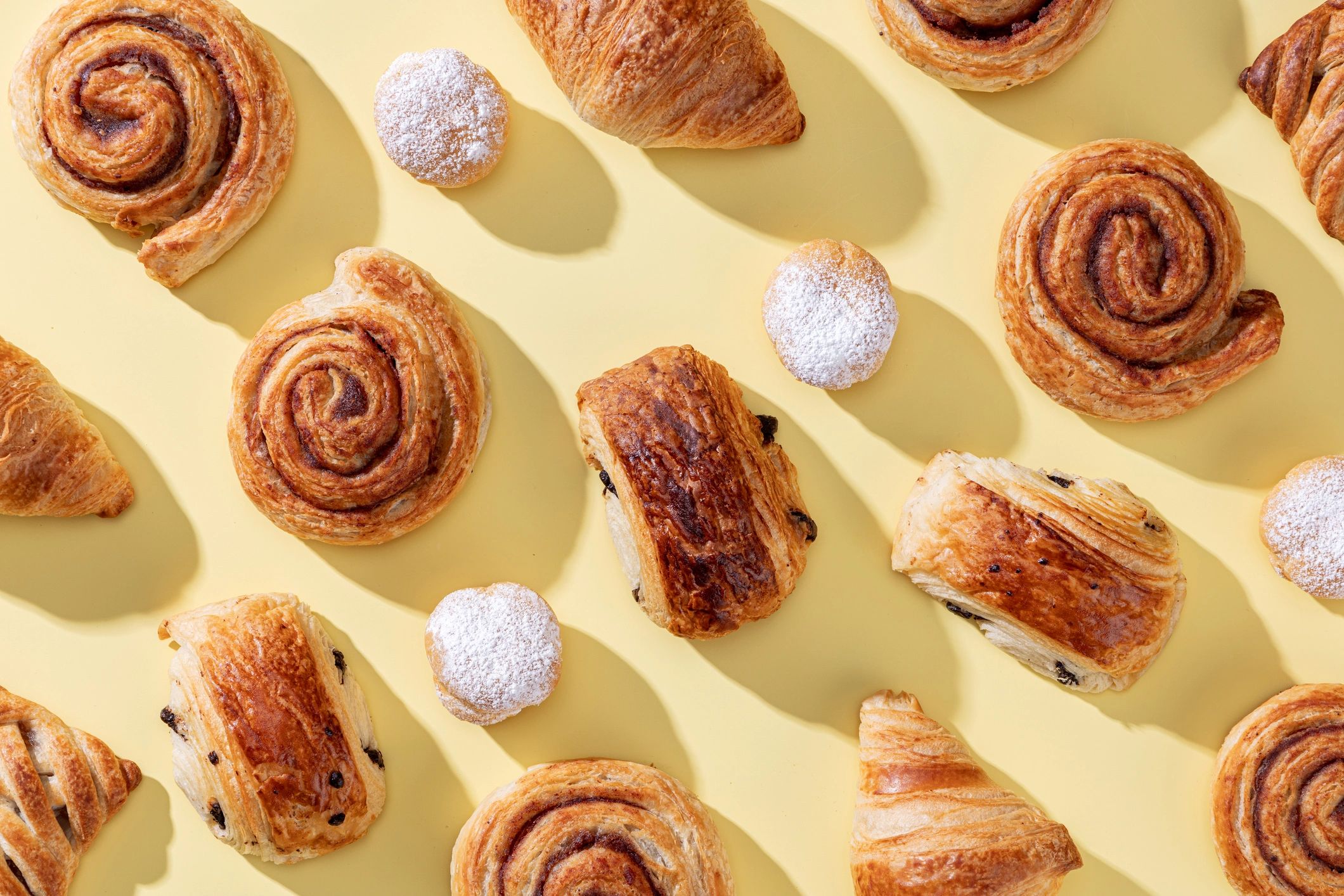 Assorted freshly baked pastries on a light background