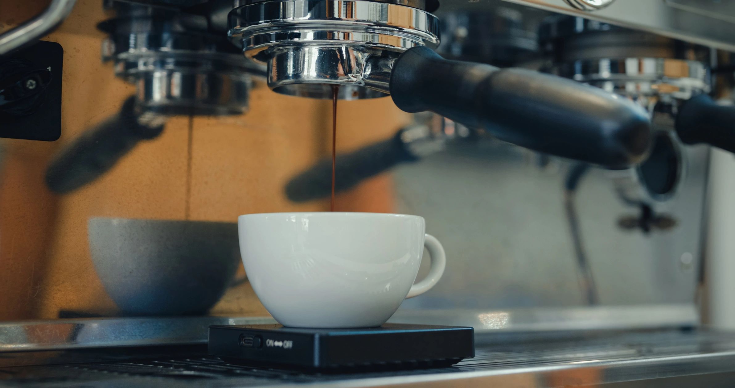 Espresso machine brewing coffee into a cup.
