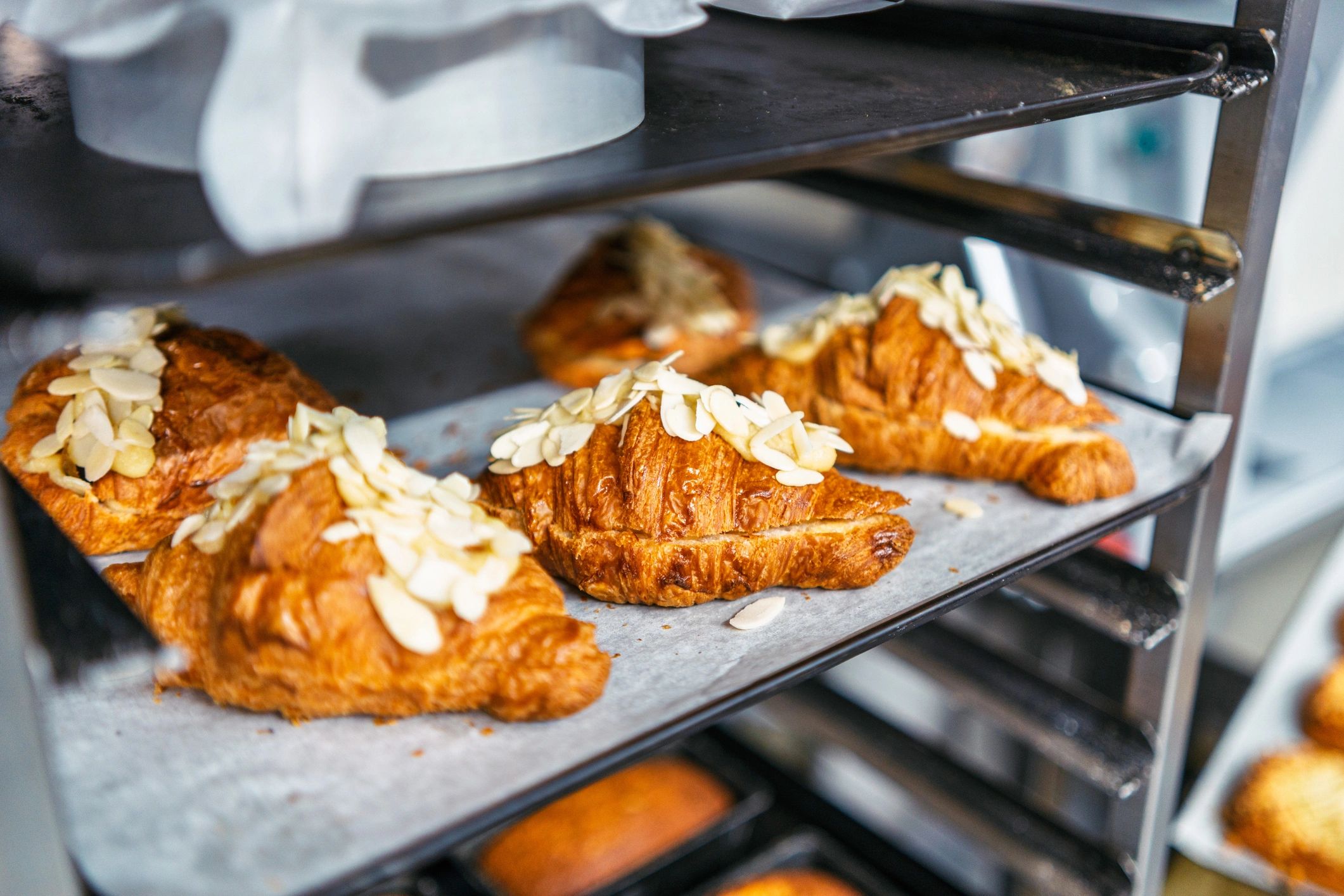 Freshly baked croissants cooling on a rack.